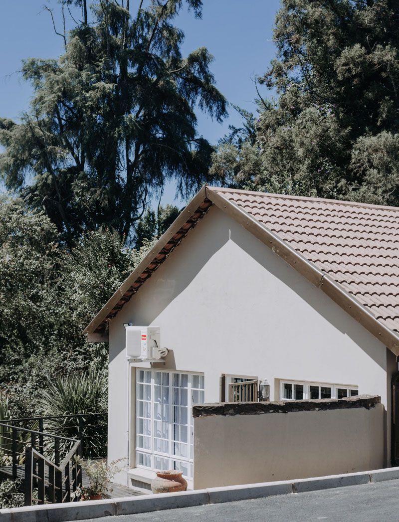 The white garden cottage with a tiled roof