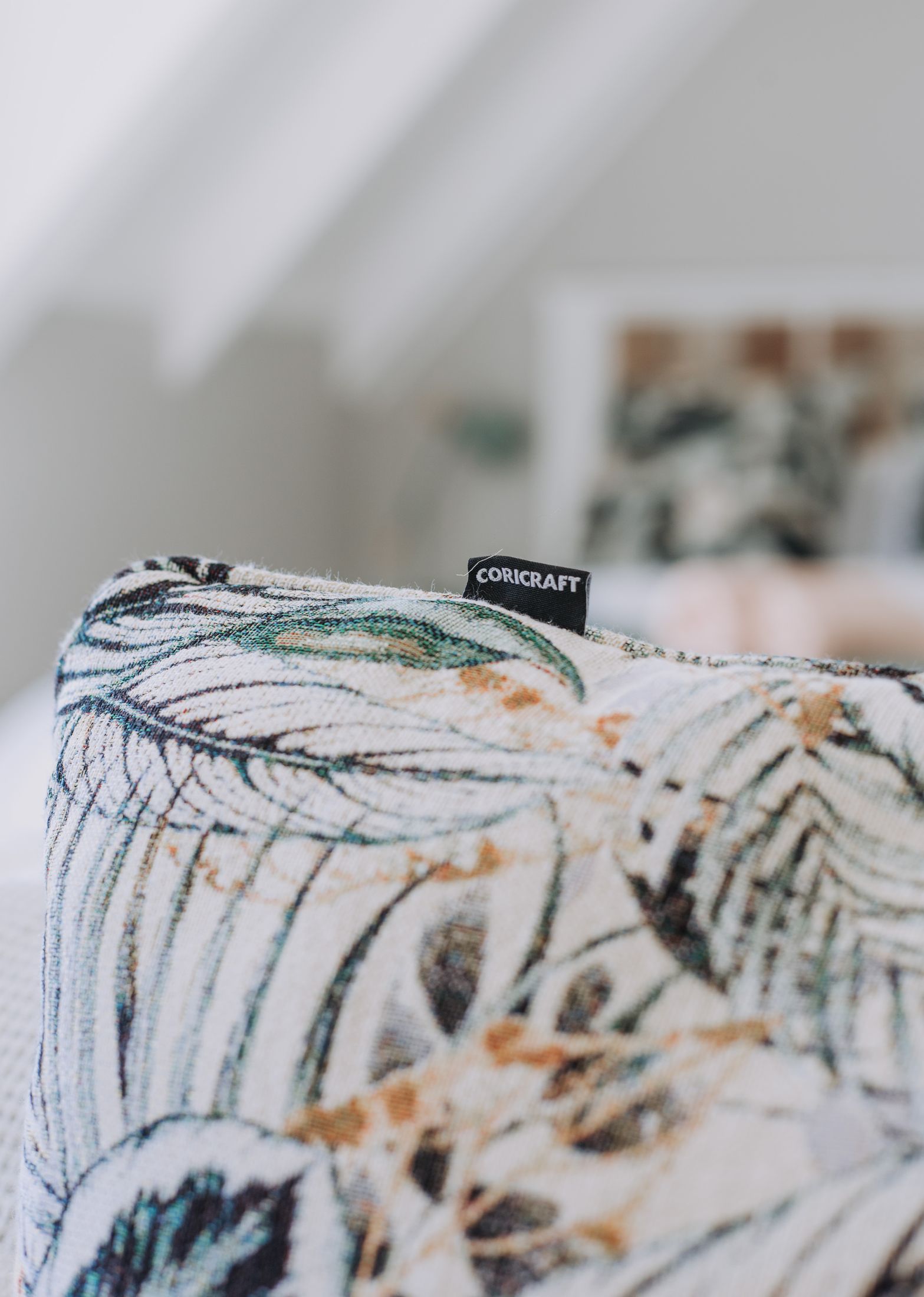 A botanical print cushion on a chair