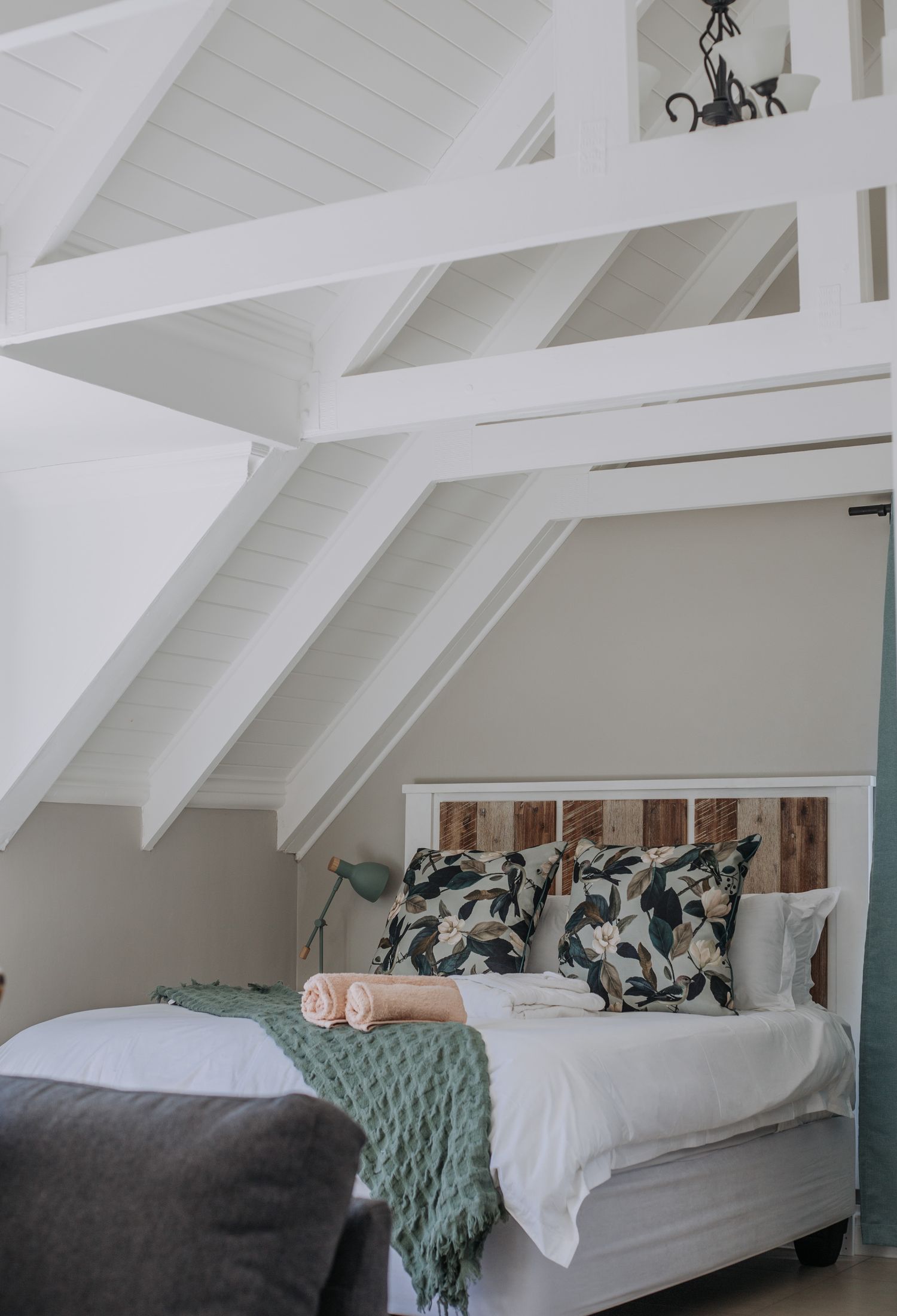 The loft bed with a couch at its foot