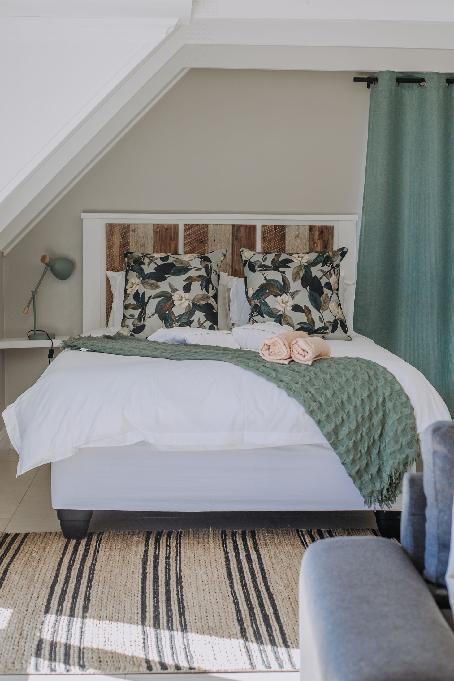 The Garlington loft bedroom under white roof trusses