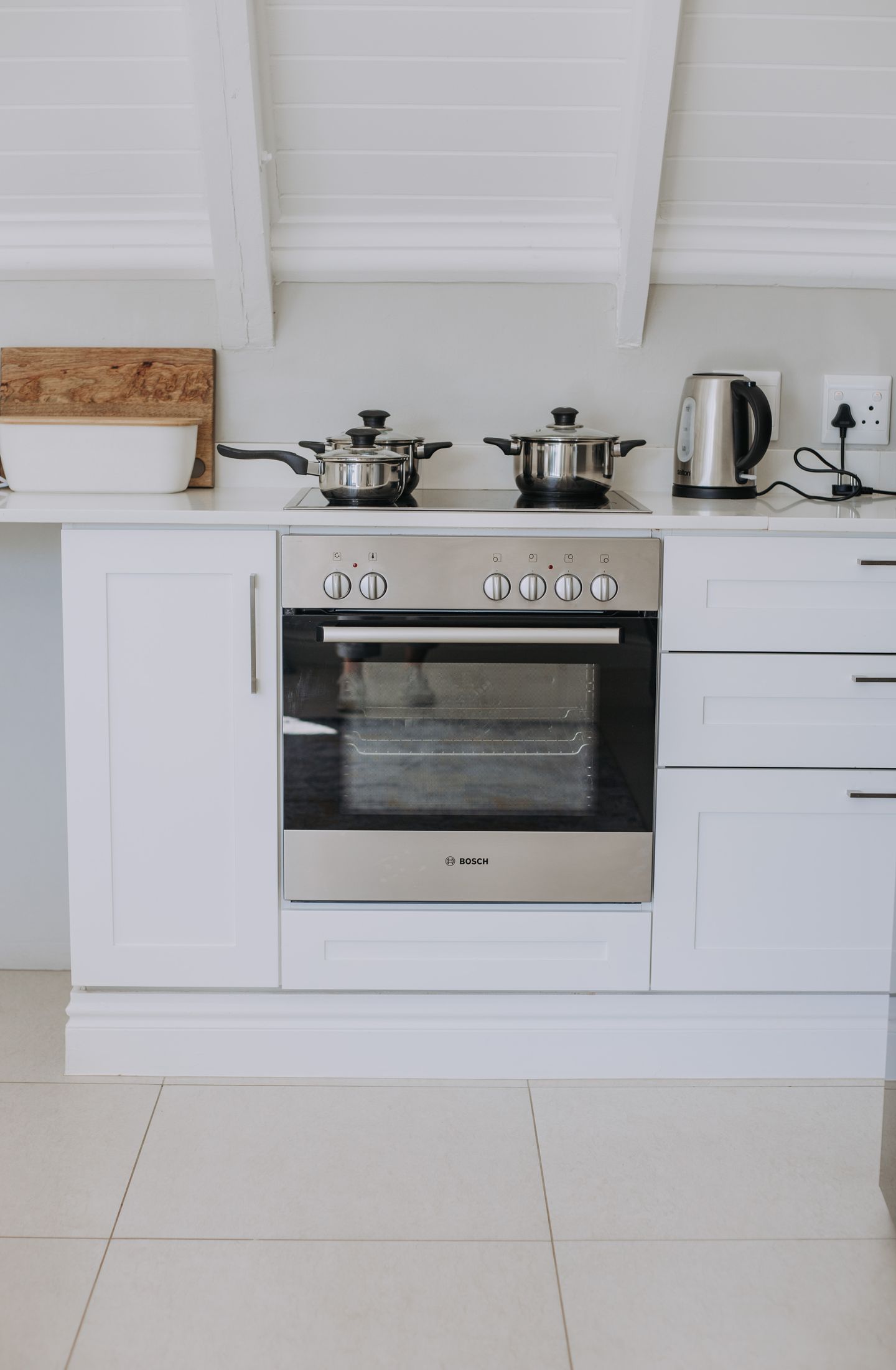 The loft kitchenette with an oven and white cupboards