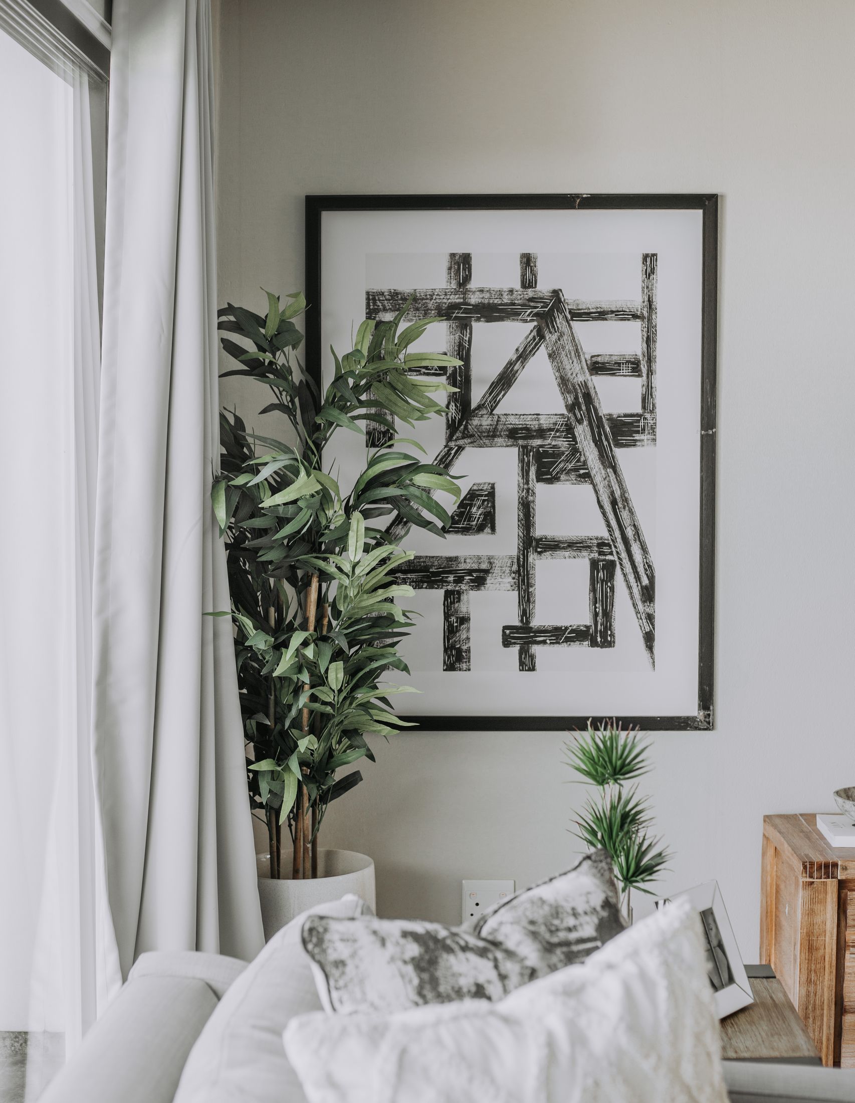 A white sofa under a black and white abstract print