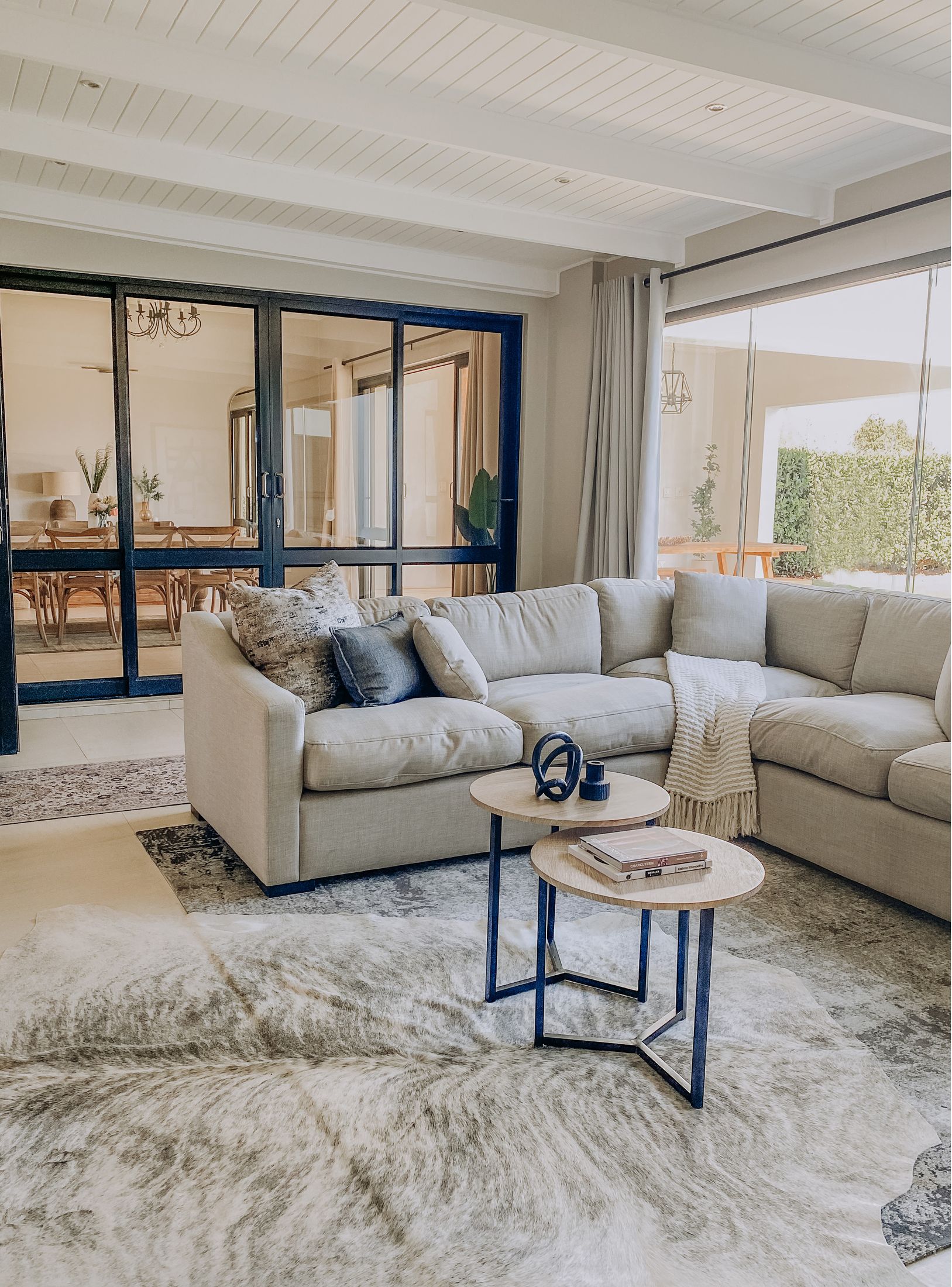 The second lounge with an L shaped couch and steel framed glass doors
