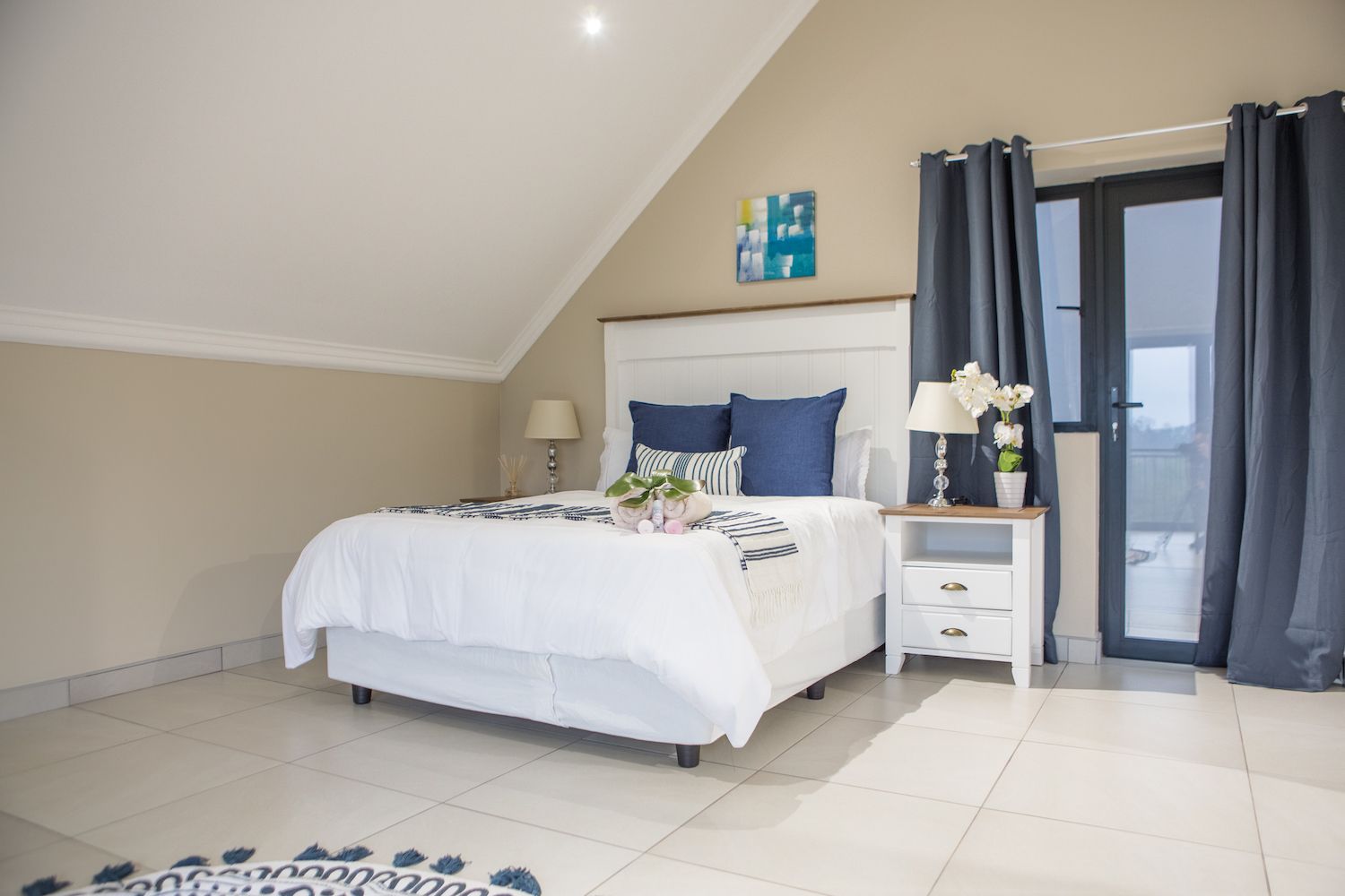 The bed in the Loft at Unit 5 under a sloped ceiling