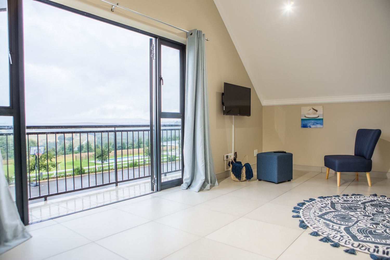 The Loft at Unit 5, an open room with a balcony door and a view of the fields