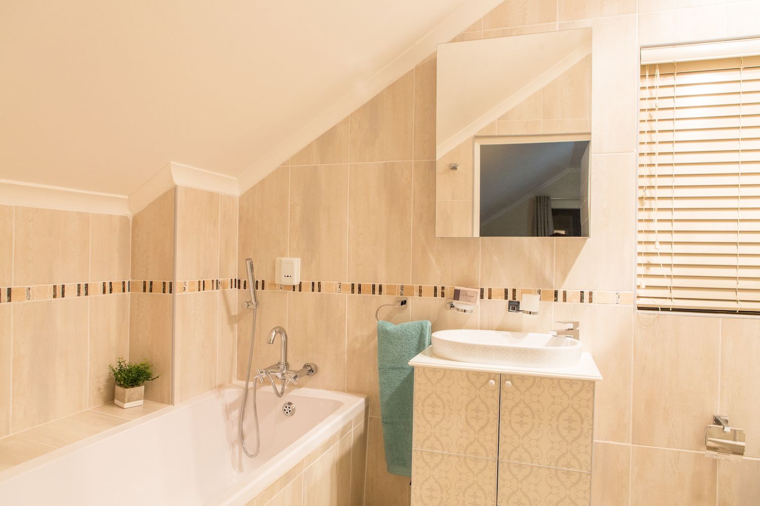 The Loft at Unit 6 bathroom, with a bath under the sloped ceiling