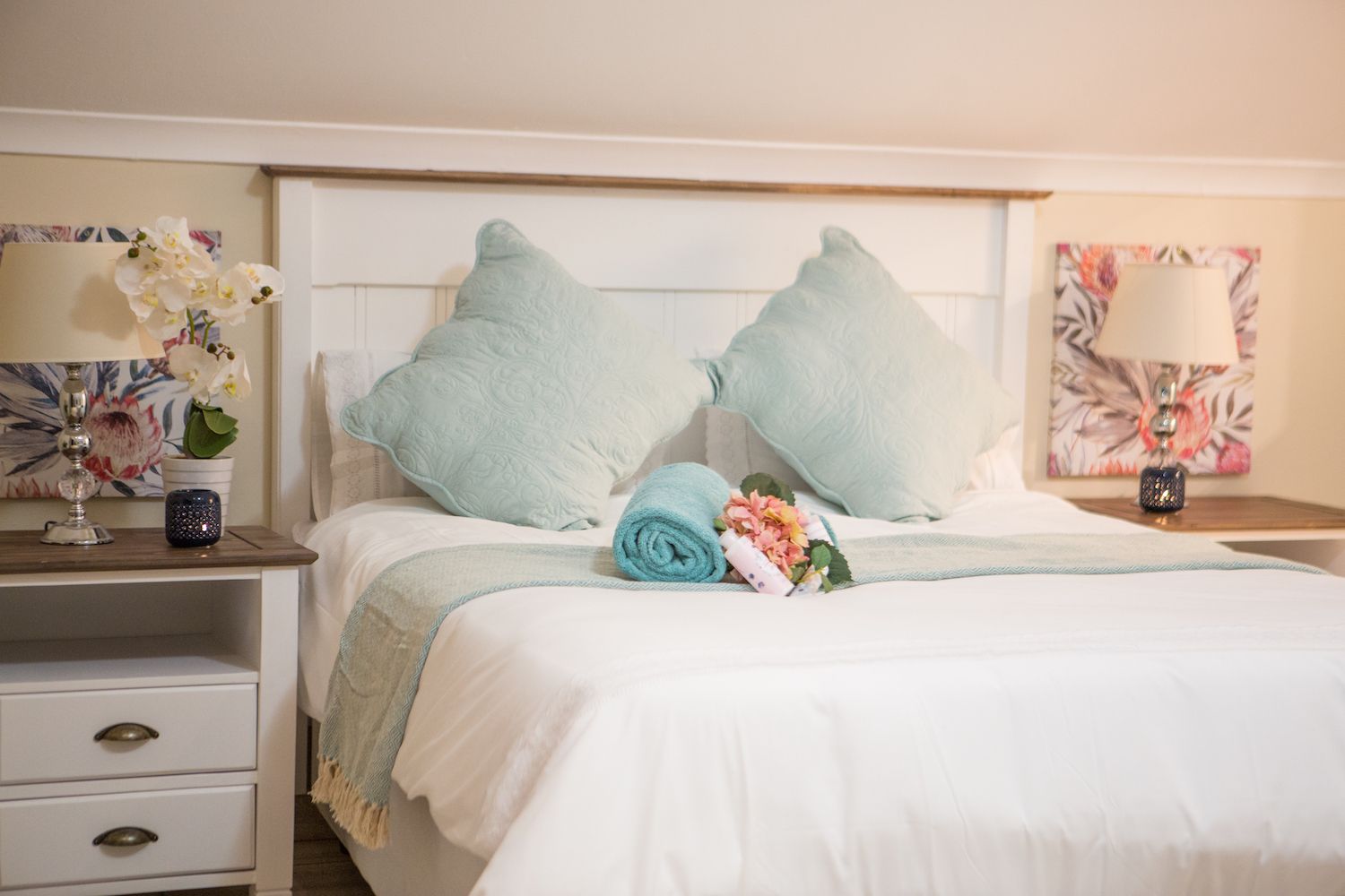 The bed in the Loft at Unit 6 with pale blue cushions