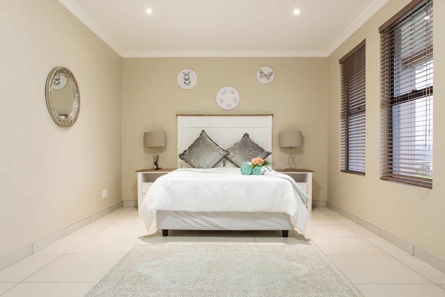 A Unit 5 bedroom with a double bed and grey curtains