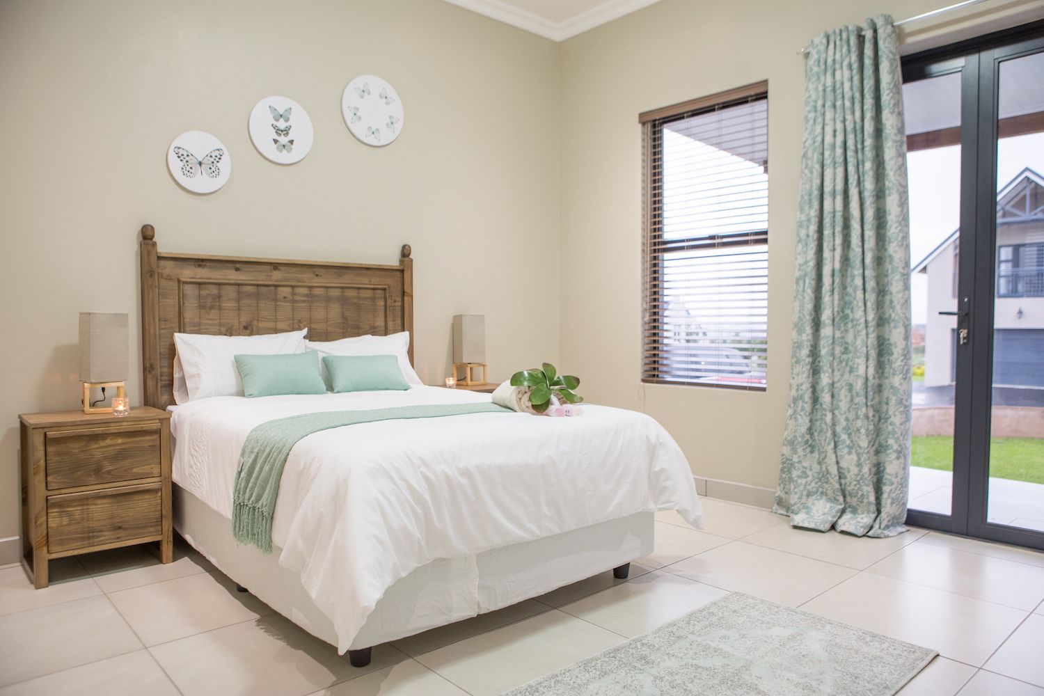 A Unit 5 bedroom with glass doors that open onto the lawn
