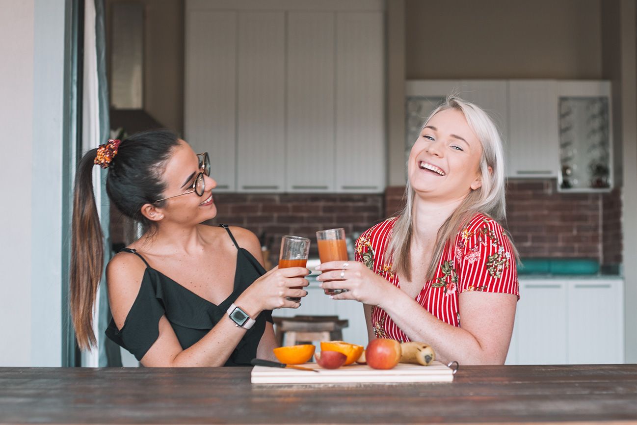 Two guests laughing at the kitchen counter in Unit 5
