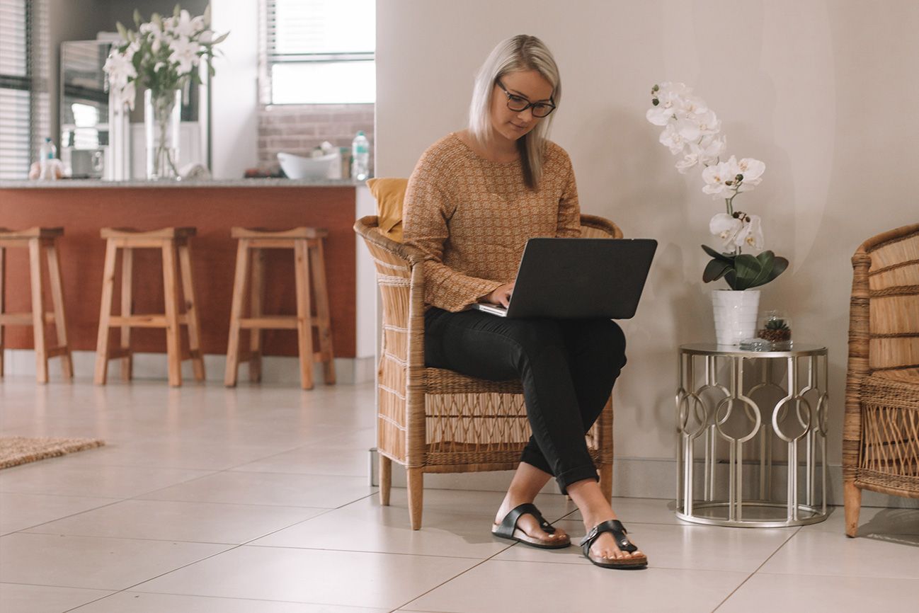 A guest working on a laptop in a chair in the Unit 5 lounge