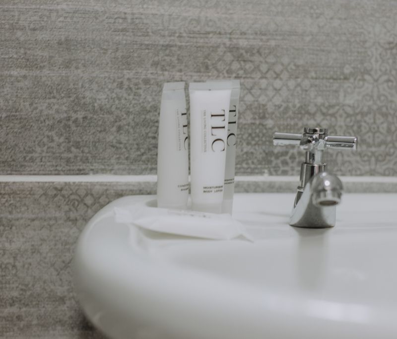 TLC toiletries on a white basin