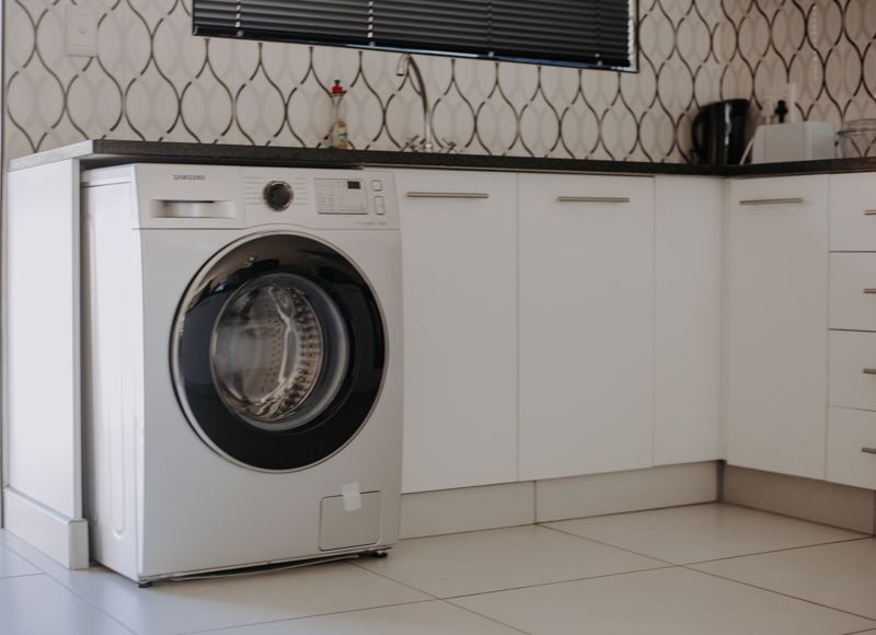 A washing machine built into the apartment kitchen