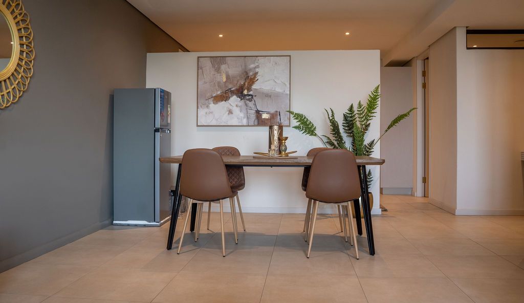 A dining table and chairs in the open plan room