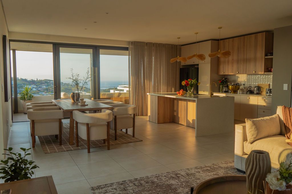 The living space opening through tall glass doors to the garden