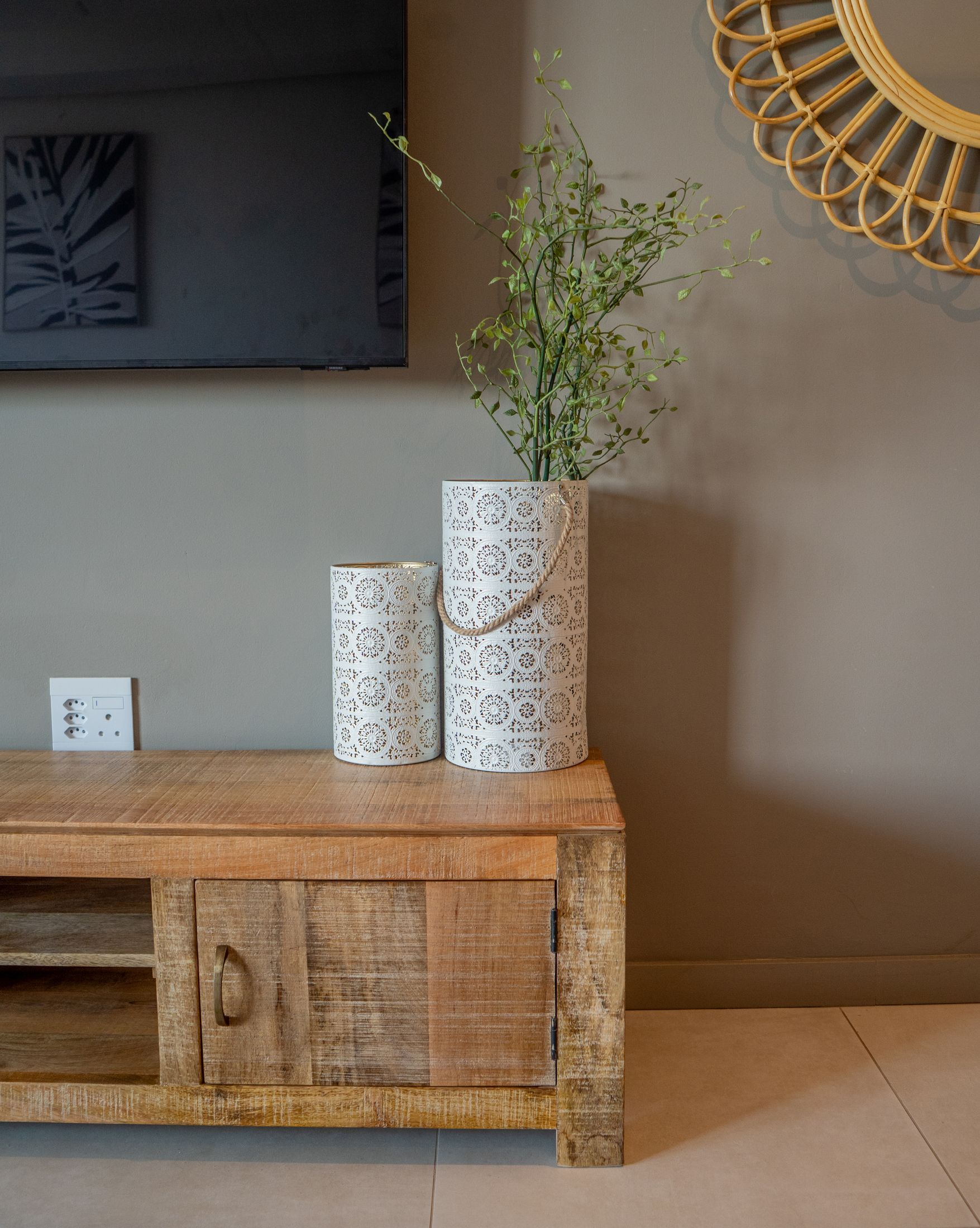 Two white vases on a rustic timber TV cabinet
